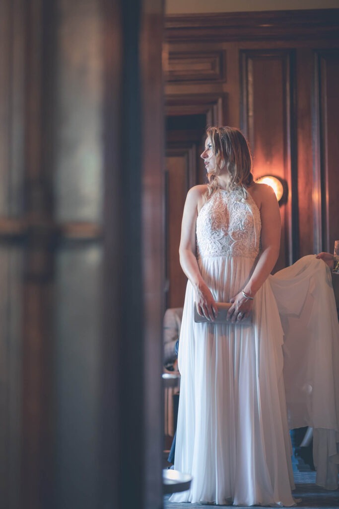 Romantic wedding moment captured: Beautiful bride caught off guard in candid, sneaky shot, showcasing genuine love and happiness on her big day