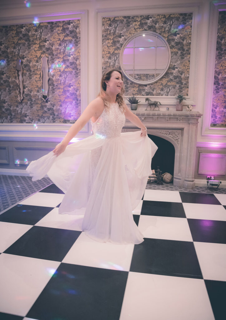 Bride dancing at wedding reception, joyful wedding celebration, wedding photographer