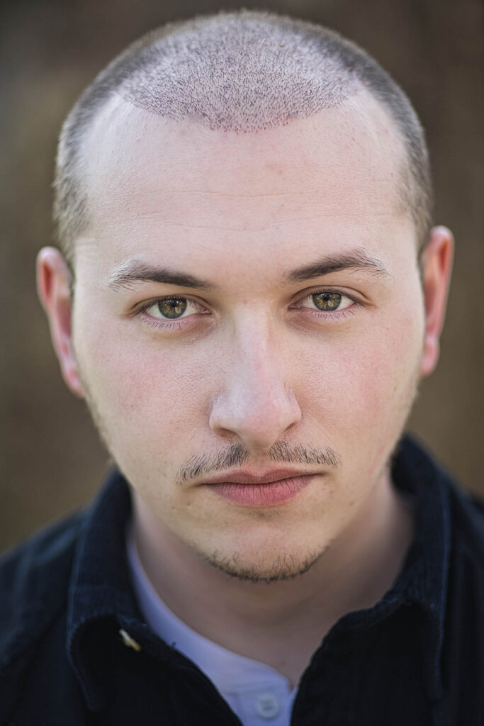 Center stage: professional actor's headshot showcases charisma and confidence, perfect for portfolio and casting calls