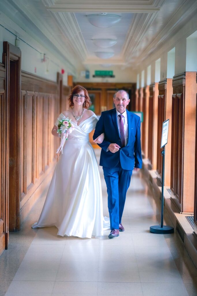 Bride being given away by father, father of the bride escorting, wedding ceremony entrance, emotional wedding moments, traditional wedding customs